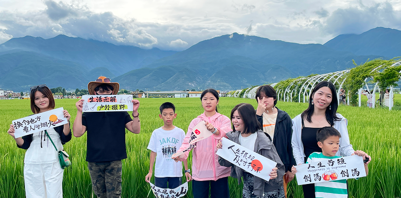 REKO sales team visiting Dali with Cangshan Mountain and Erhai Lake in the background, experiencing Bai culture during their Yunnan trip.
