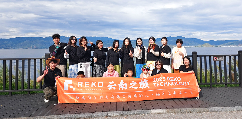 REKO sales team holding a company banner in Yunnan, representing REKO company culture, teamwork, and one shared goal.