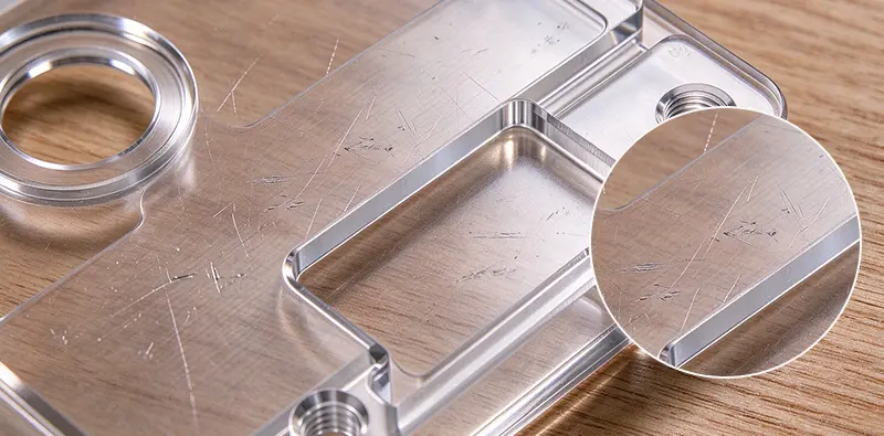 CNC-machined acrylic parts with cloudy edges and machining marks before polishing